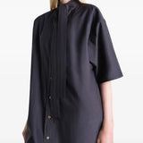 Black dresses worn by a person, showing the dresses fit