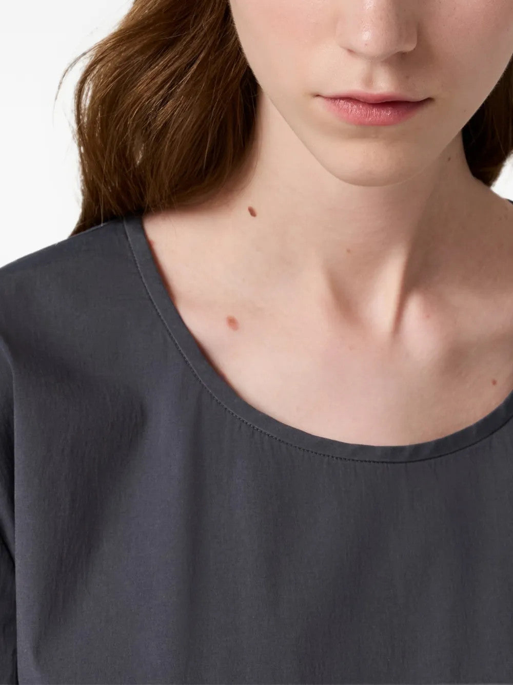 Grey top worn by a person, showing the top fit