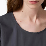 Grey top worn by a person, showing the top fit
