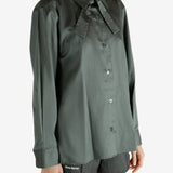 Green shirt worn by a person, showing the shirt's fit