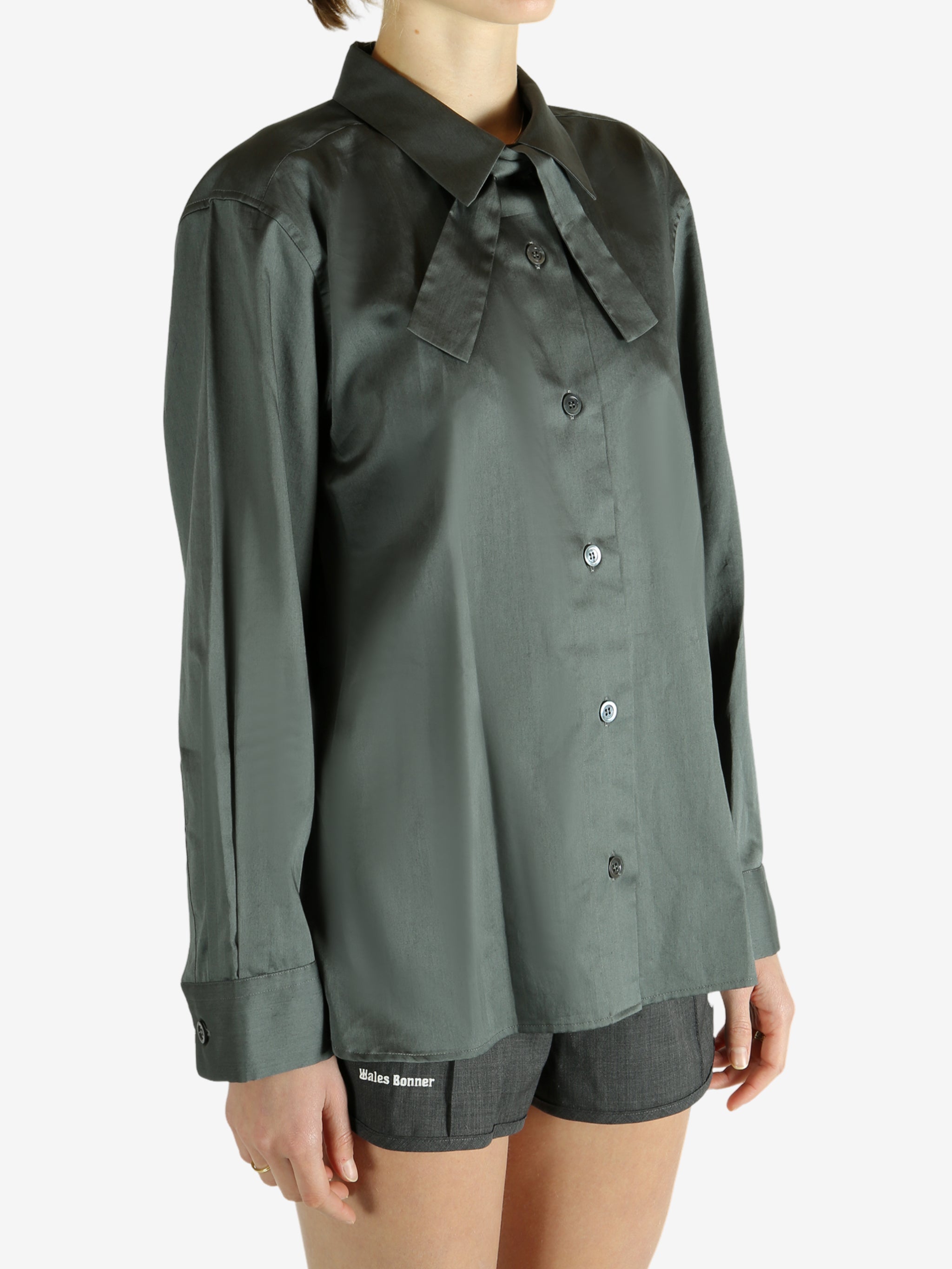 Green shirt worn by a person, showing the shirt's fit