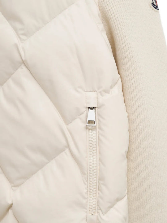 Close up of White knitwear, showing texture of the 87% virgin wool/ 9% cashmere/ 3% polyamide/ 1% elastane made in fabric