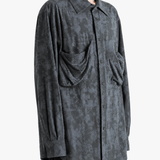 Grey shirt worn by a person, showing the shirt fit
