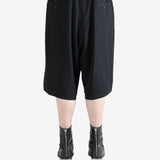 Black pants worn by a person, showing the pants's fit