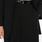 Close up of black pants, showing texture of the virgin wool and polyamide fabric