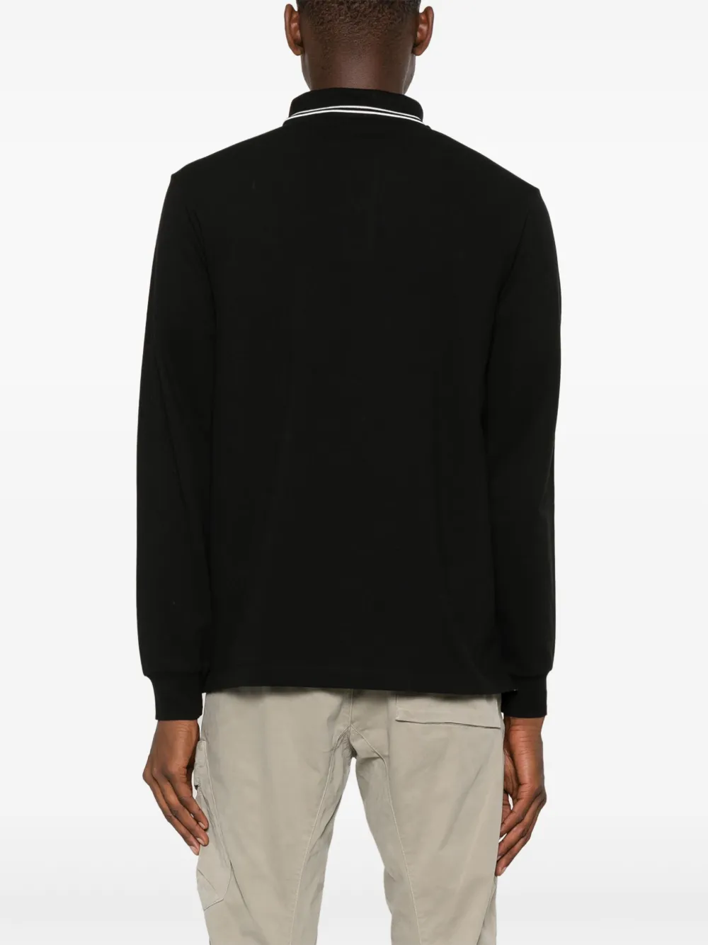 Black shirt worn by a person, showing the shirt's fit