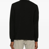 Black shirt worn by a person, showing the shirt's fit