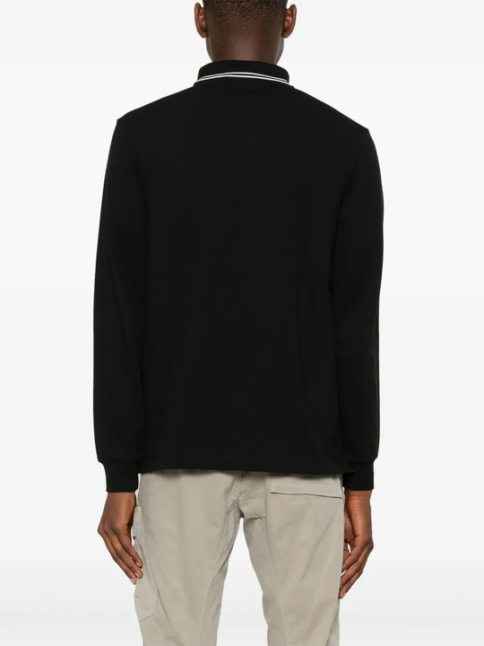 Black shirt worn by a person, showing the shirt's fit