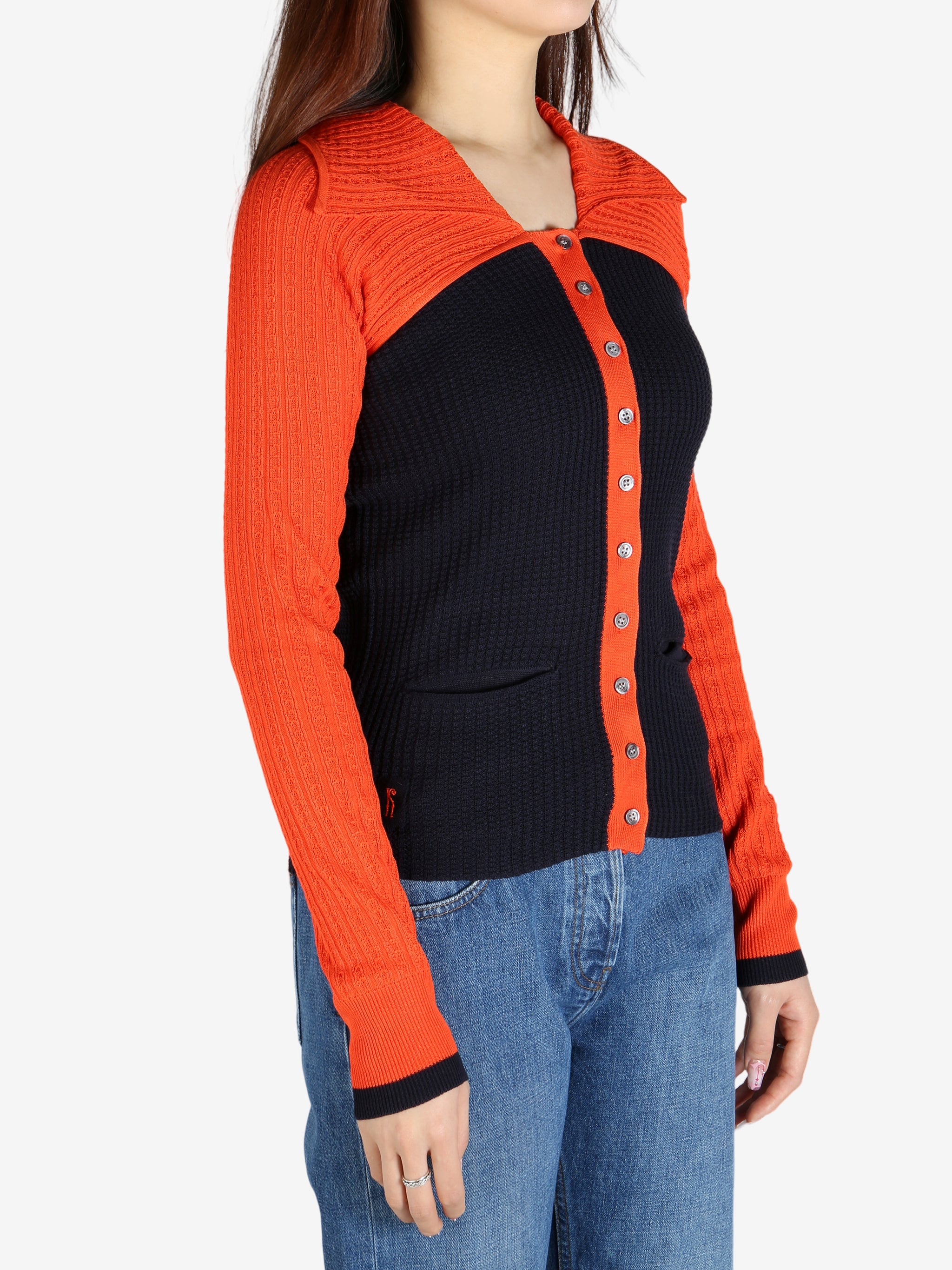 Orange top worn by a person, showing the top’s fit