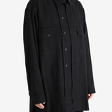 Black shirt worn by a person, showing the shirt fit
