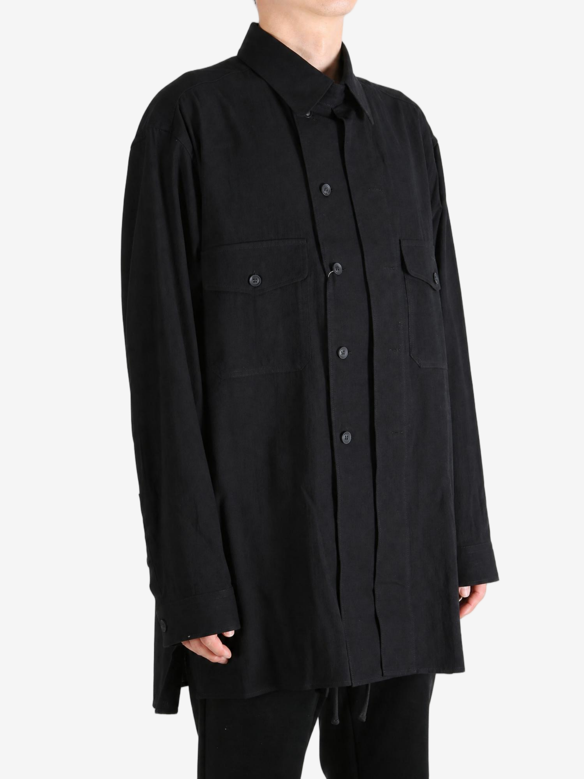 Black shirt worn by a person, showing the shirt fit