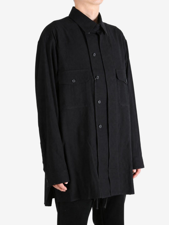Black shirt worn by a person, showing the shirt fit