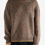 Brown knitwear worn by a person, showing the knitwear's fit