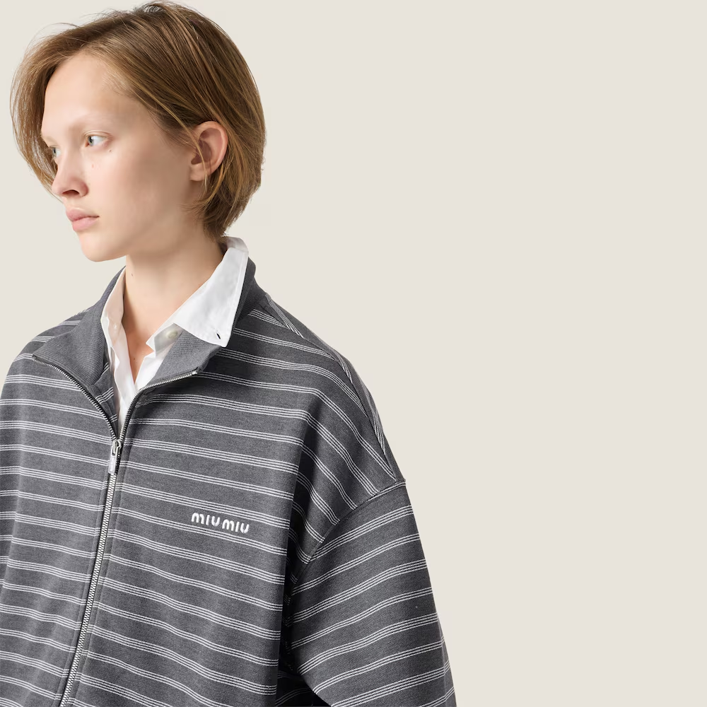 Tan knitwear worn by a person, showing the knitwear fit