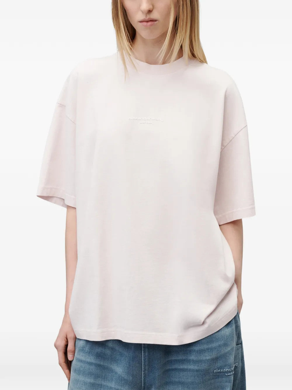 Pink t-shirt worn by a person, showing the t-shirt fit
