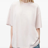 Pink t-shirt worn by a person, showing the t-shirt fit
