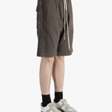 Brown shorts worn by a person, showing the shorts fit