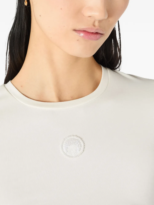 Close up of white tops, showing texture of the cotton fabric