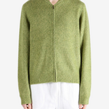 Green hoodie worn by a person, showing the hoodie fit
