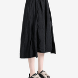 Black pants worn by a person, showing the pants fit