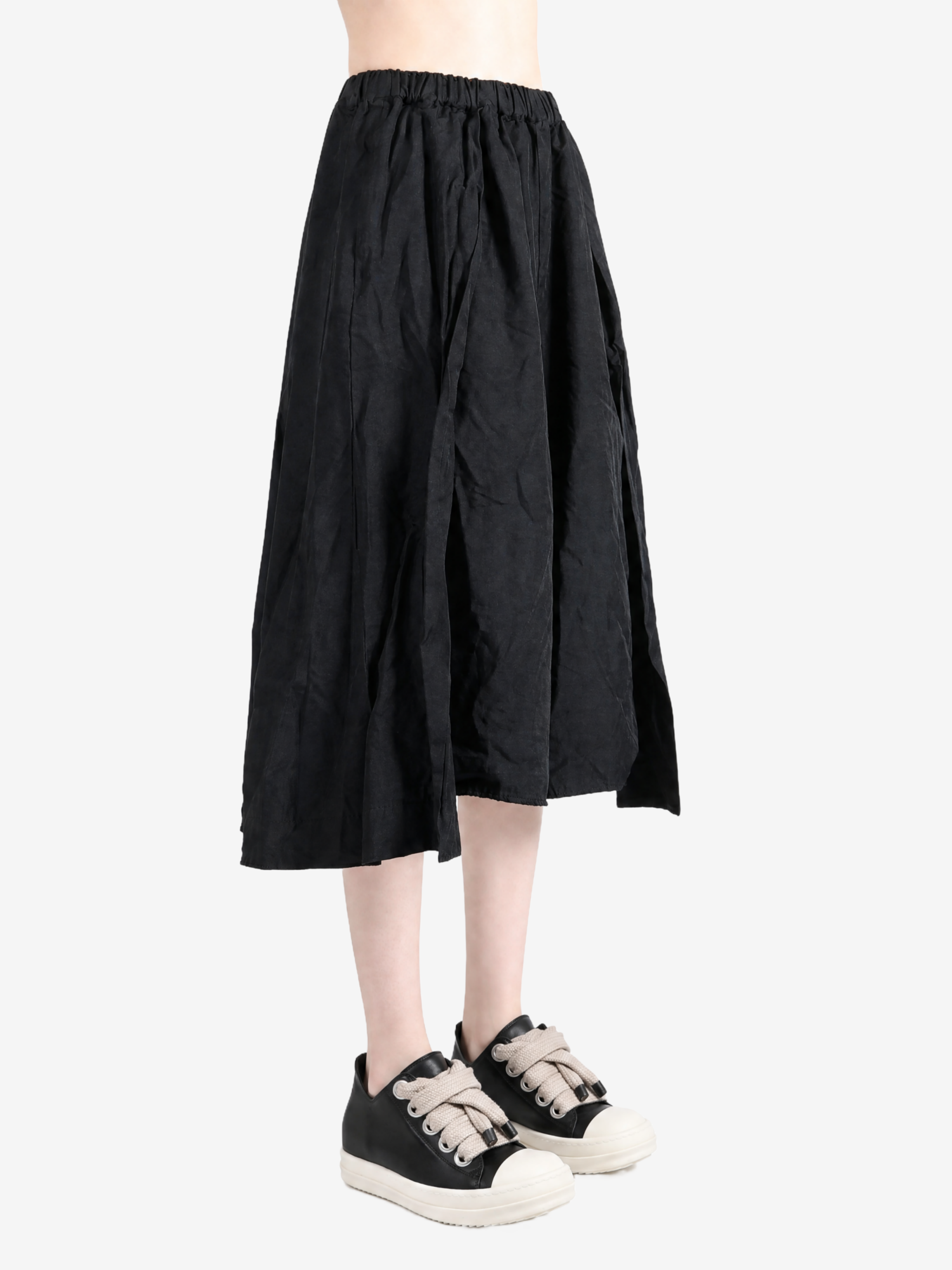 Black pants worn by a person, showing the pants fit