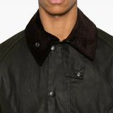 Green jacket worn by a person, showing the jacket fit