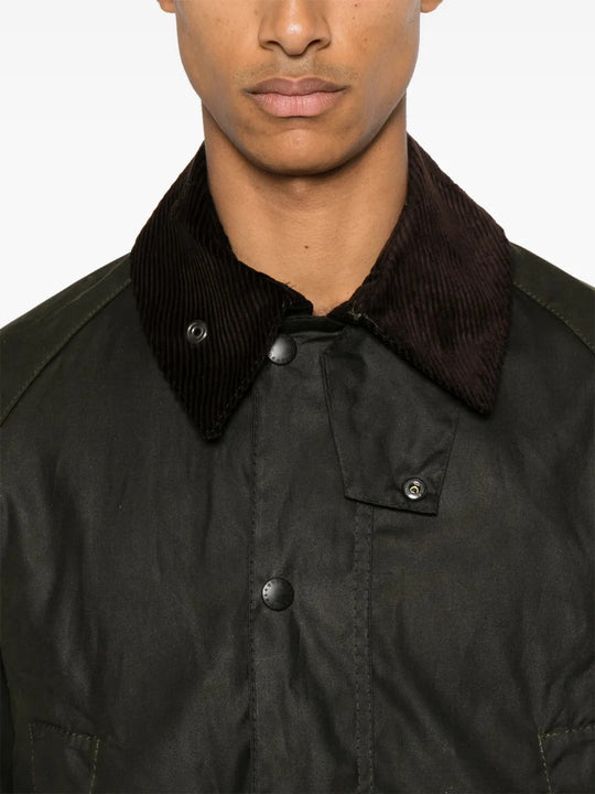 Green jacket worn by a person, showing the jacket fit