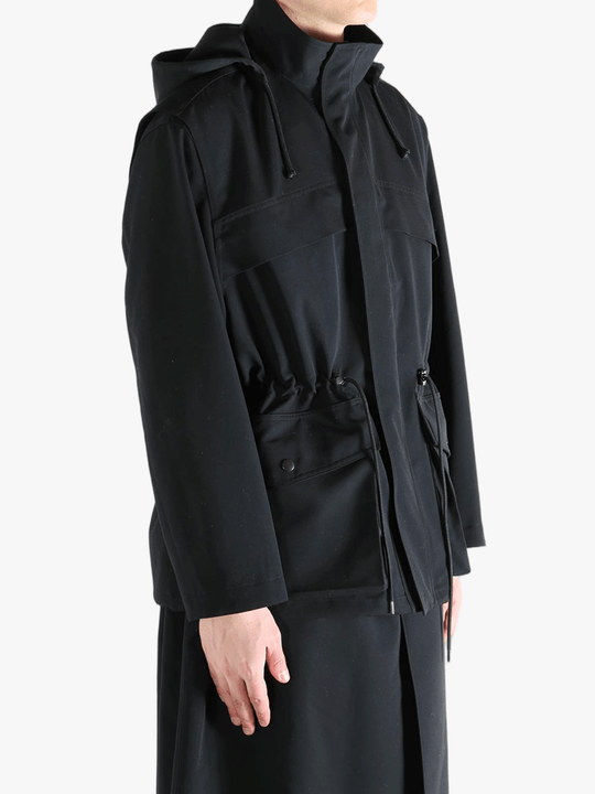 Black jacket worn by a person, showing the jacket fit