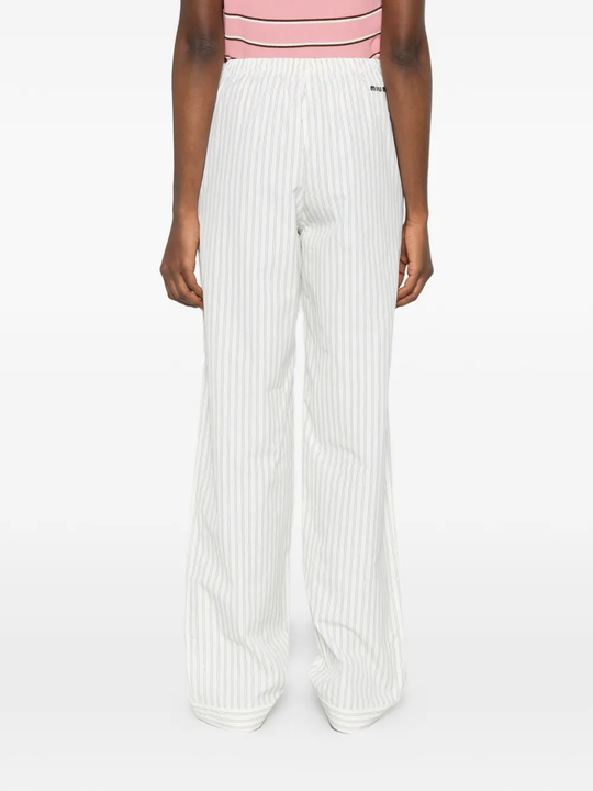 White pants worn by a person, showing the pants fit