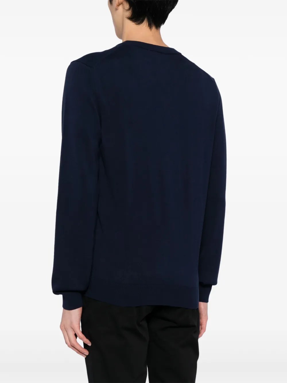 Navy sweater worn by a person, showing the sweater fit