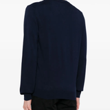 Navy sweater worn by a person, showing the sweater fit