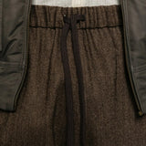 Close up of Brown pants, showing texture of the 57% wool/ 21% polyester/ 12% polyamide/ 8% linen/ 2% other fabric