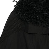 Close up of Black jacket, showing texture of the 50% cotton/ 50% polyester fabric