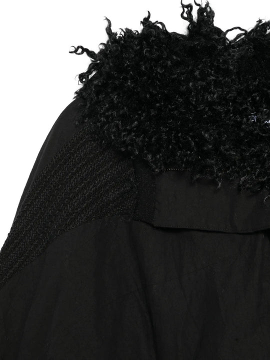 Close up of Black jacket, showing texture of the 50% cotton/ 50% polyester fabric