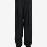 Black pants worn by a person, showing the pants fit