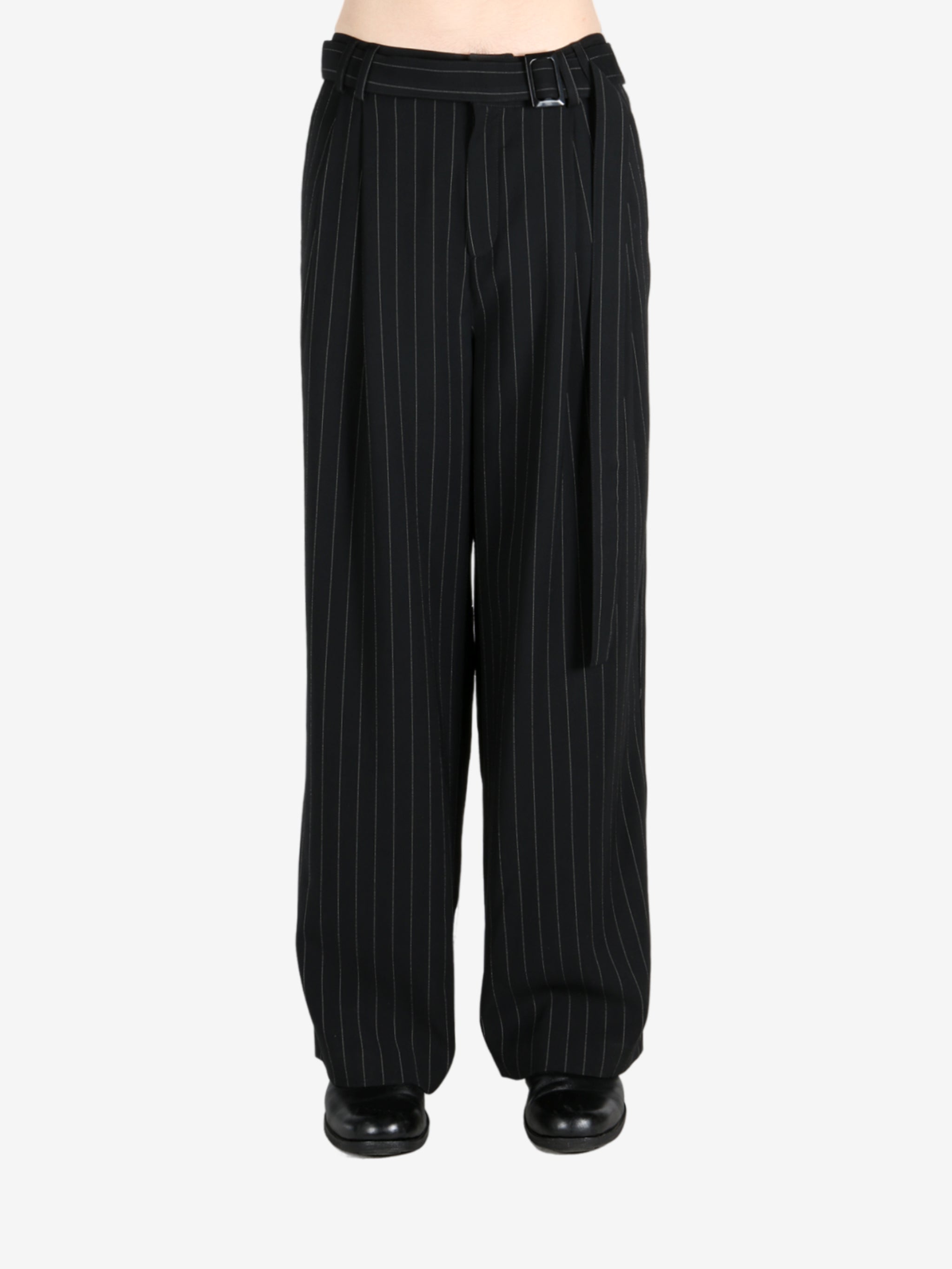 Black pants worn by a person, showing the pants fit