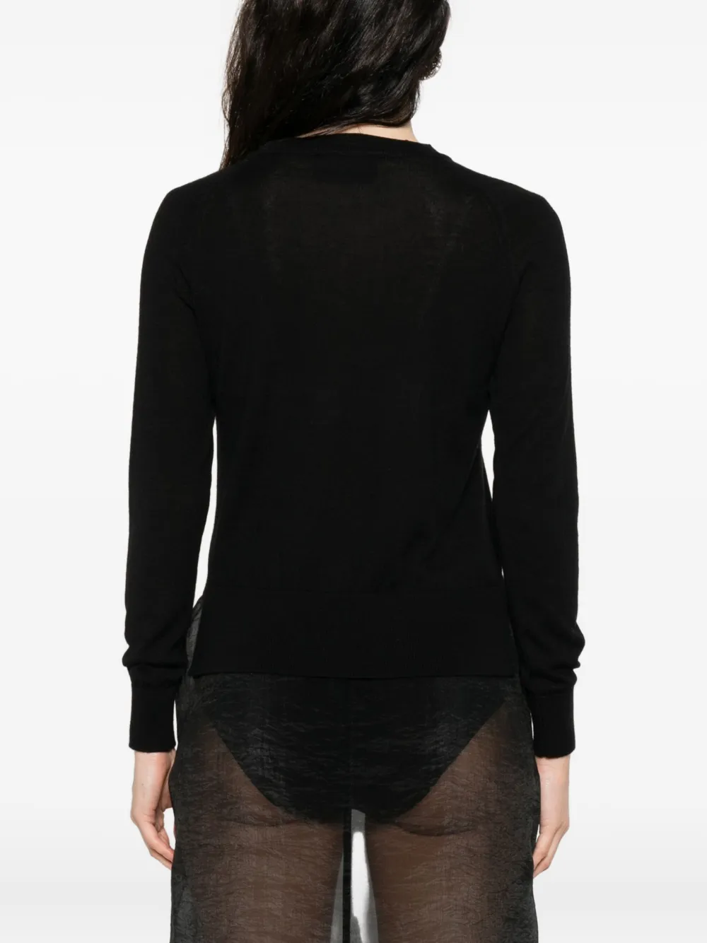 Black knitwear worn by a person, showing the knitwear's fit