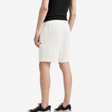 White shorts worn by a person, showing the shorts fit