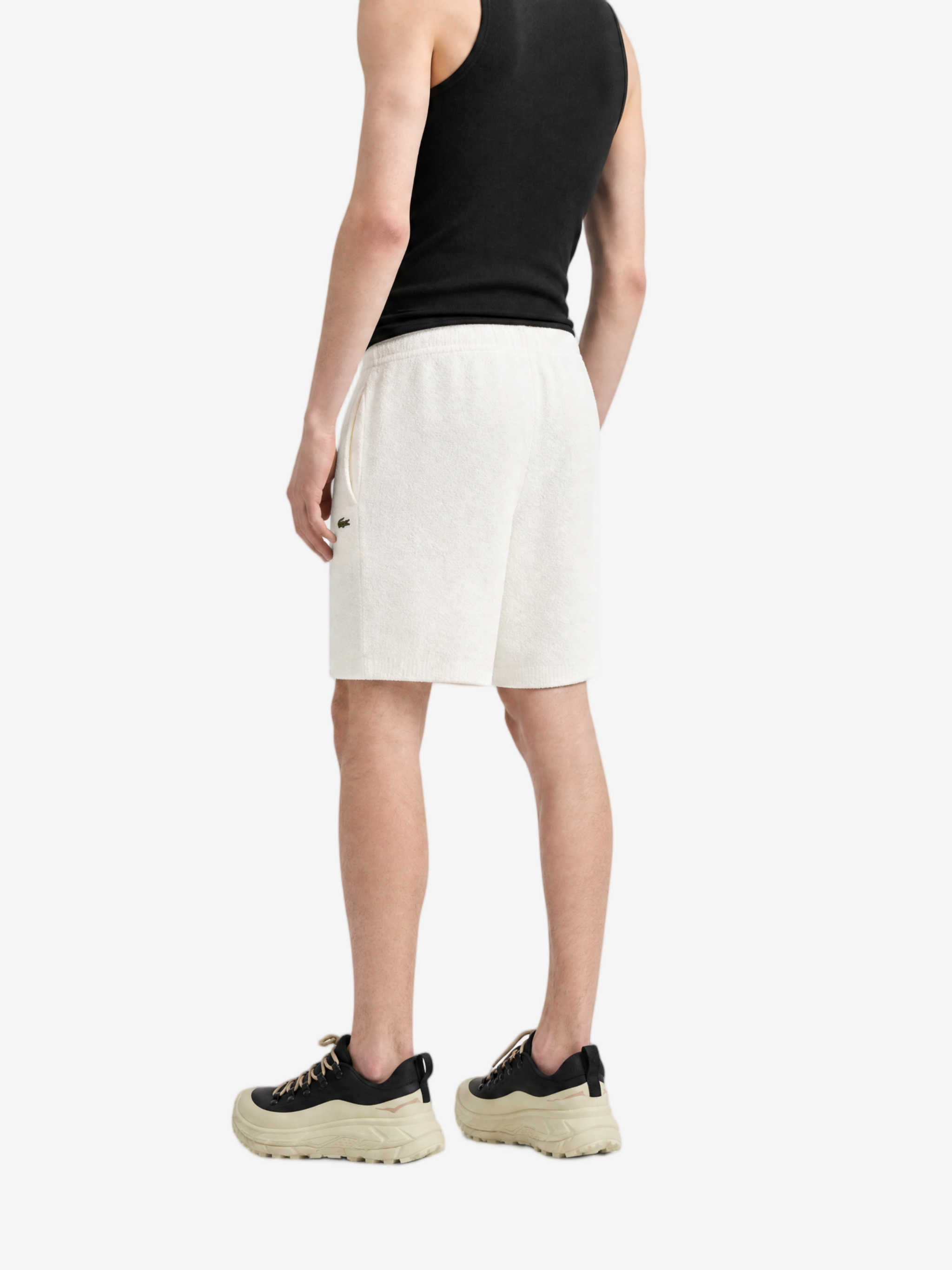 White shorts worn by a person, showing the shorts fit