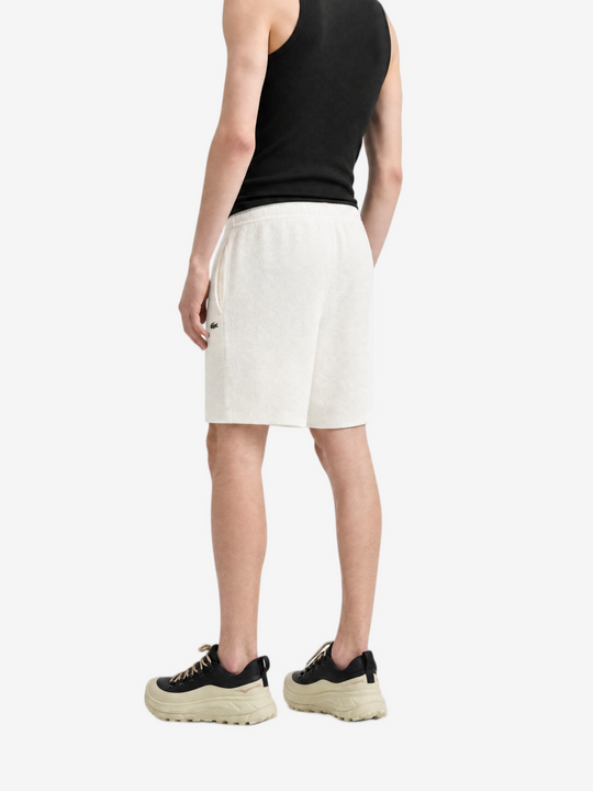 White shorts worn by a person, showing the shorts fit