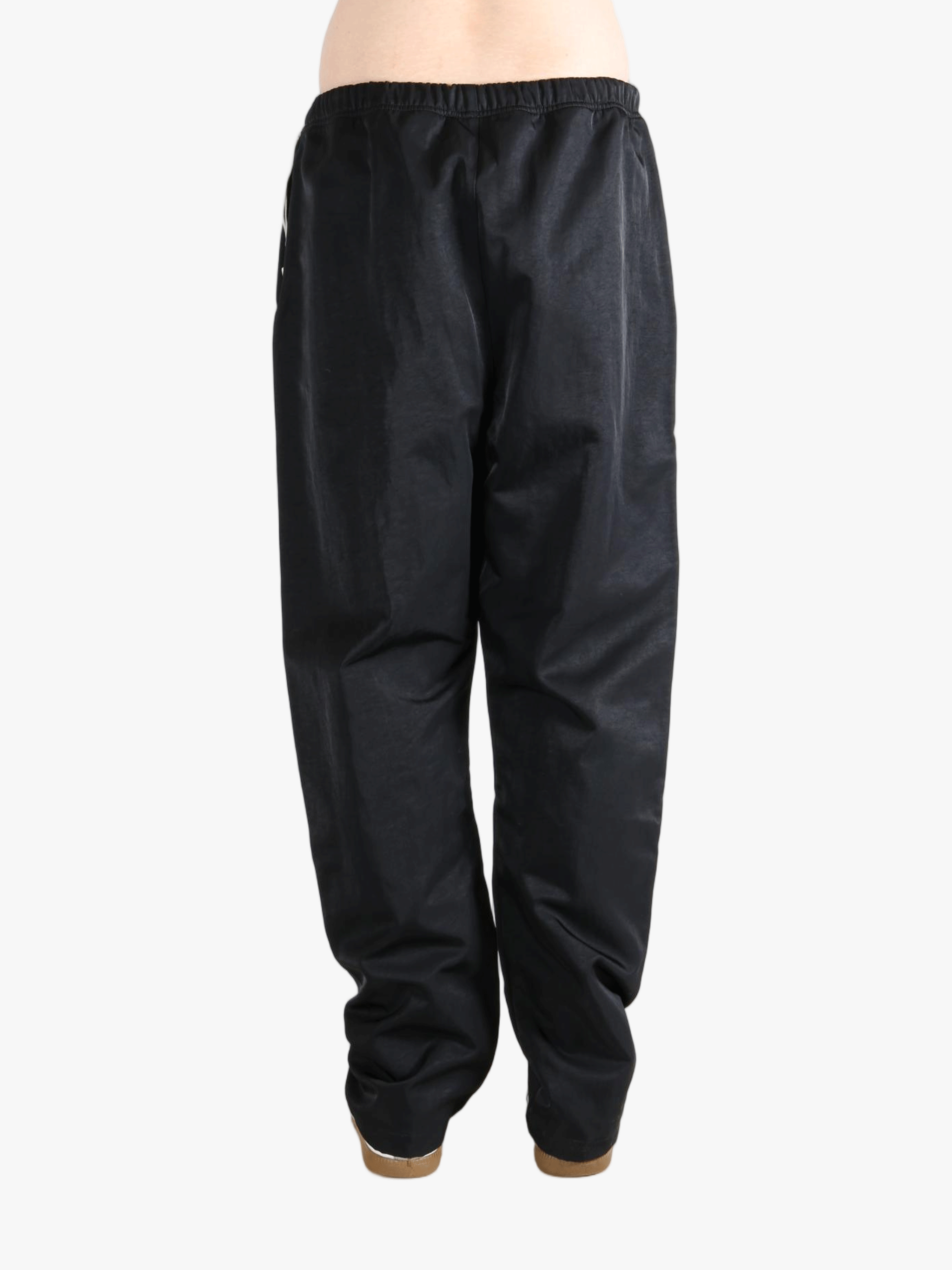 Black pants worn by a person, showing the pants's fit
