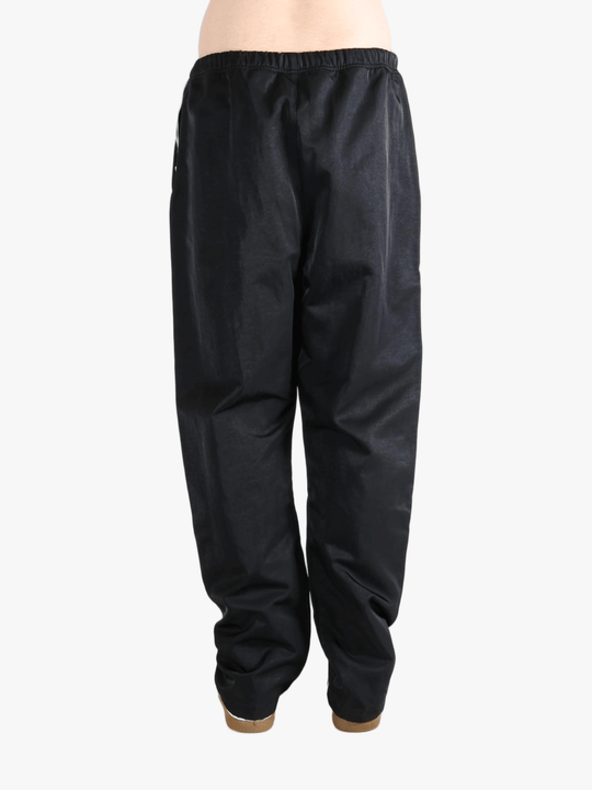 Black pants worn by a person, showing the pants's fit