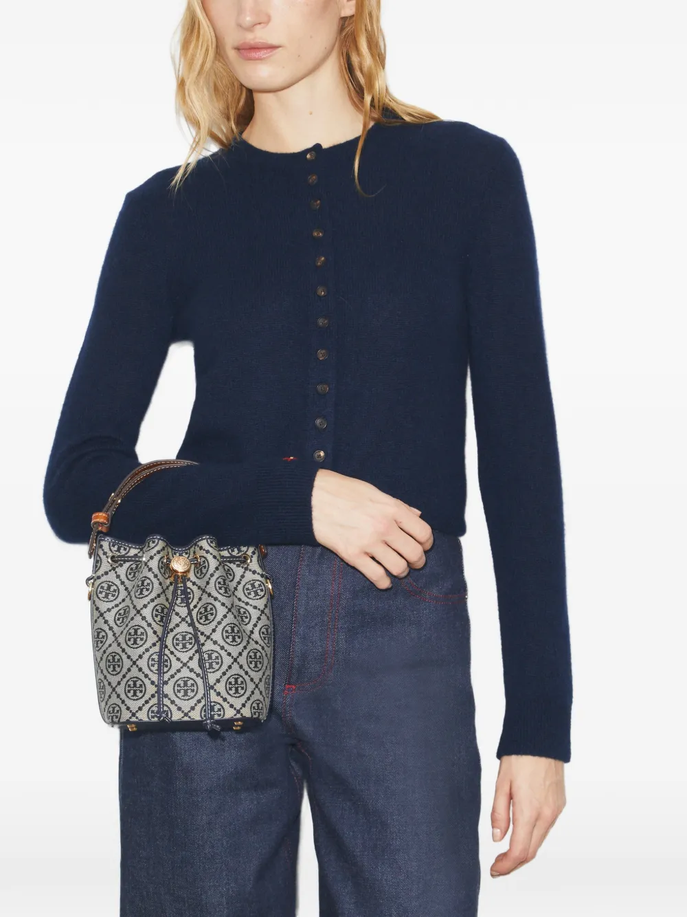 Navy bucket bag by a person, showing the bucket bag fit