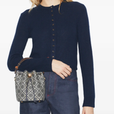 Navy bucket bag by a person, showing the bucket bag fit