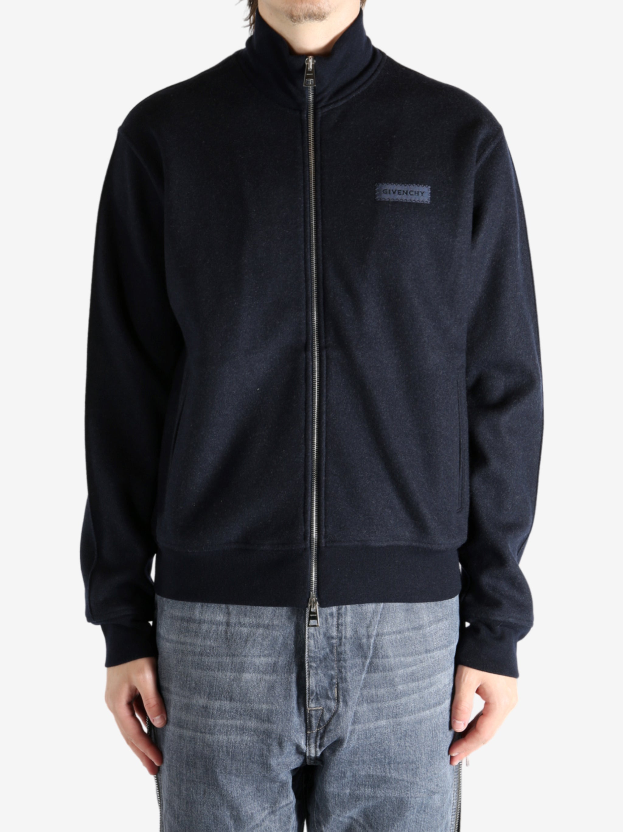 Navy coat worn by a person, showing the coat's fit