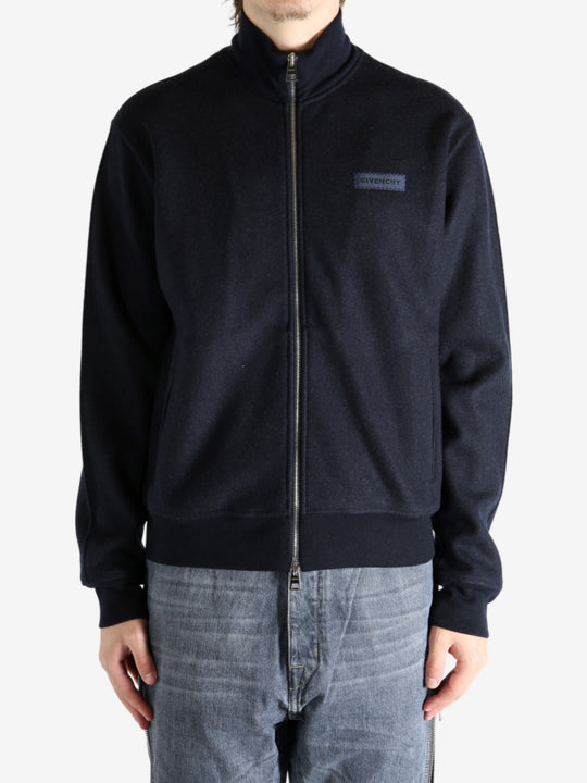 Navy coat worn by a person, showing the coat's fit