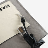 Close up of grey bag, showing texture of the leather fabric