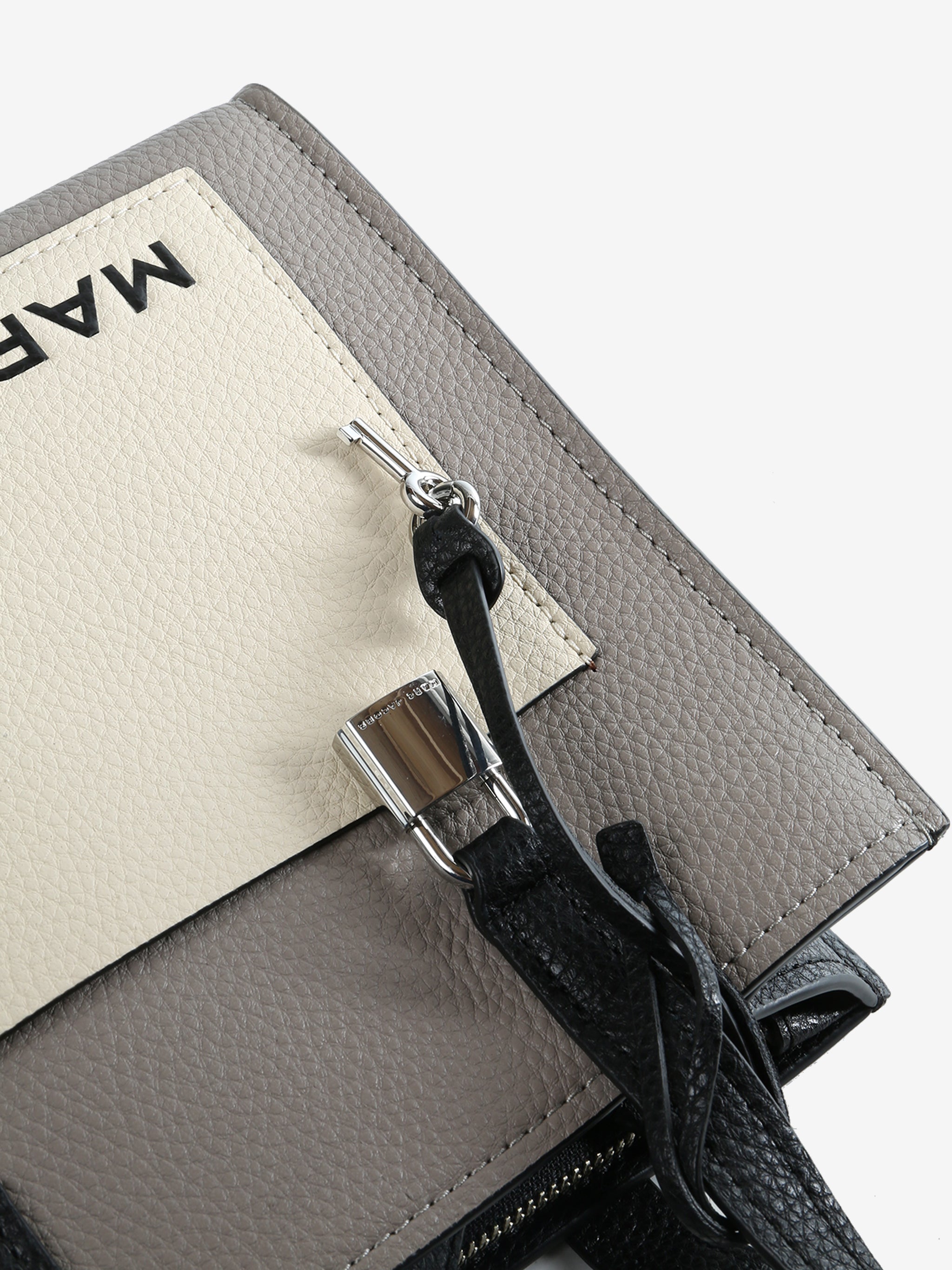 Close up of grey bag, showing texture of the leather fabric