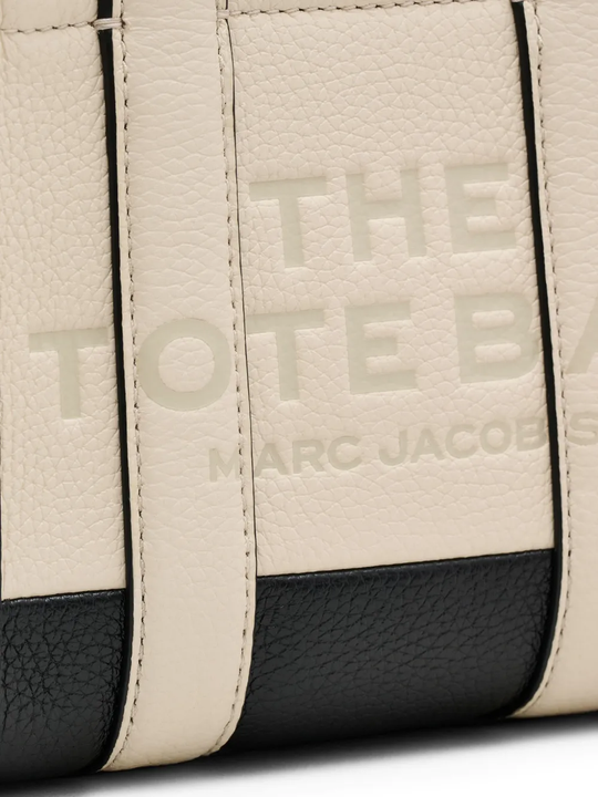 Close up of tan bags, showing texture of the cow leather fabric