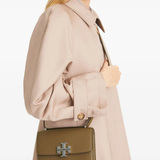 Brown bags worn by a person, showing the bags fit